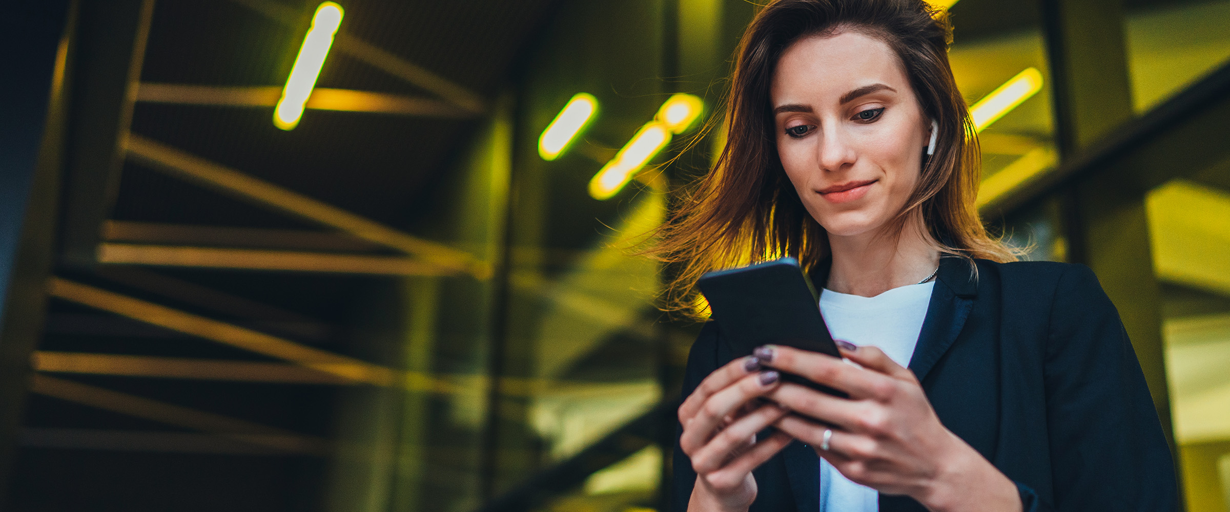 Photo of a woman looking at her smartphone.